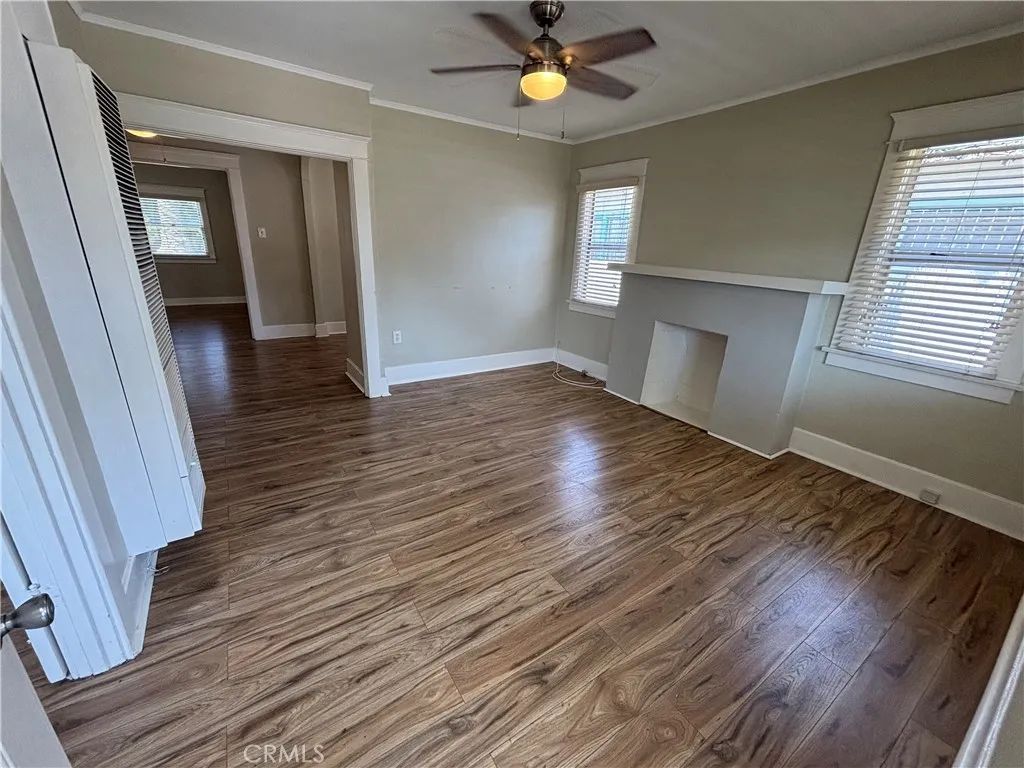 Living room with faux fireplace & Newer Ceiling Fan that  leads into Dining Area