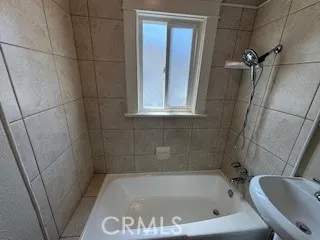 Tiled Shower Walls with newly Reglazed Bathtub & Shower head/hose