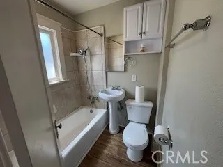 Bathroom with Newer sink, toilet, cabinet, fixtures and showerhead