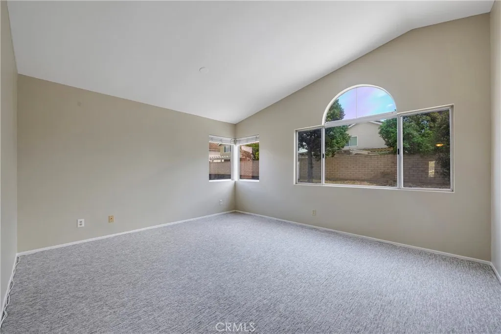 Primary bedroom has cathedral ceiling.