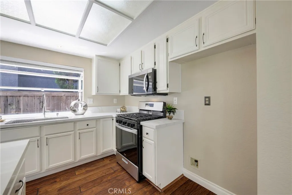 Kitchen has microwave a freestanding gas stove.