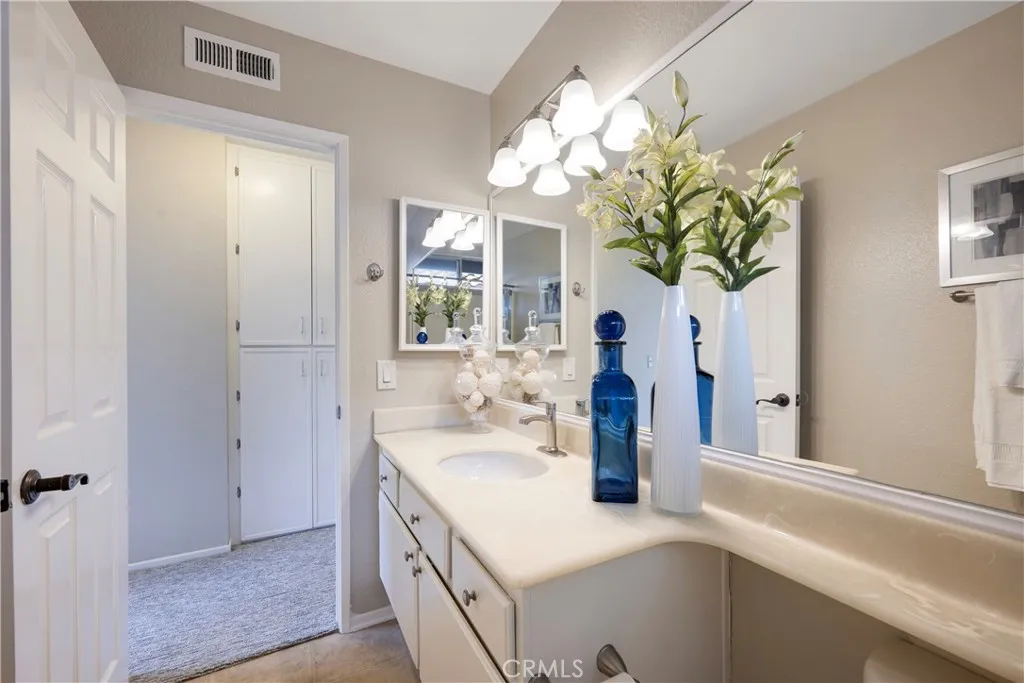 Second story hall bathroom has large mirror.