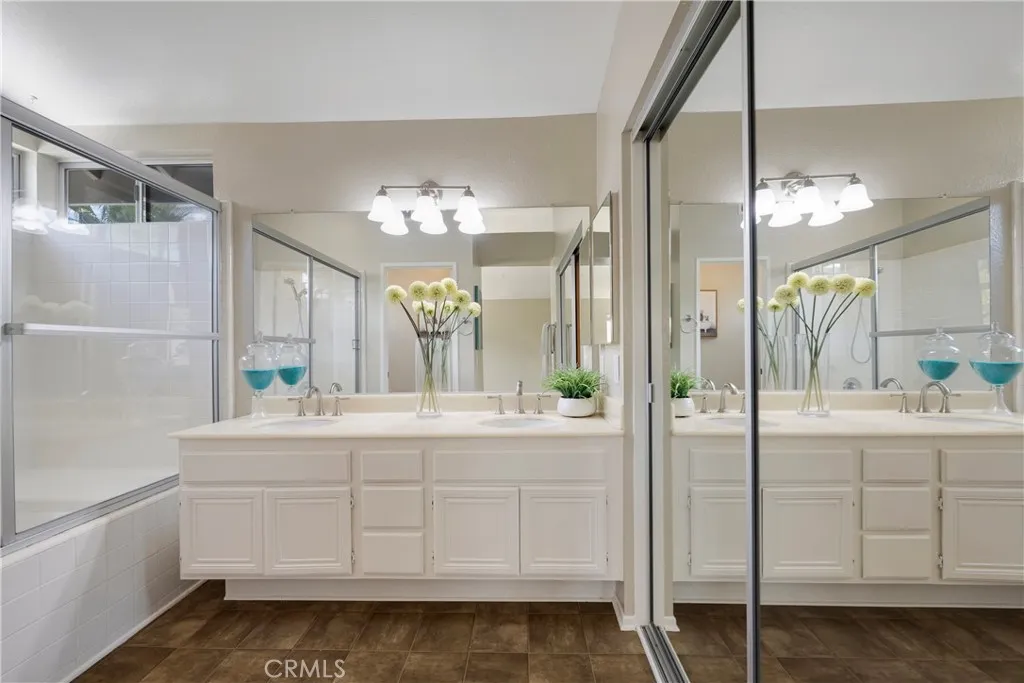 Primary bath area has closet, dual sinks & tub/shower.