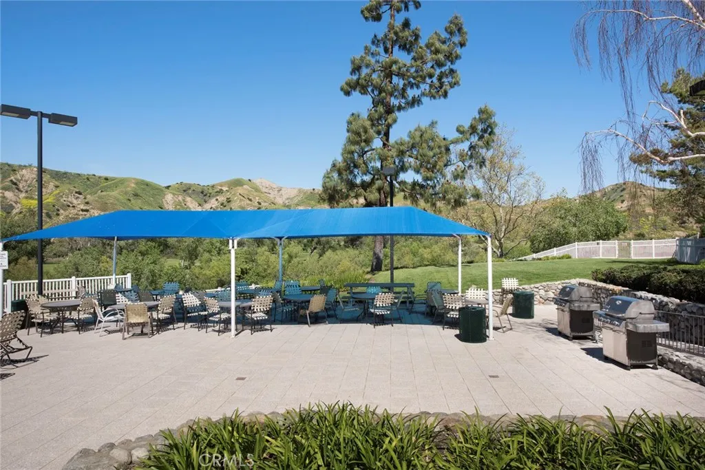 View of barbecue and picnic table area from Association clubhouse steps.
