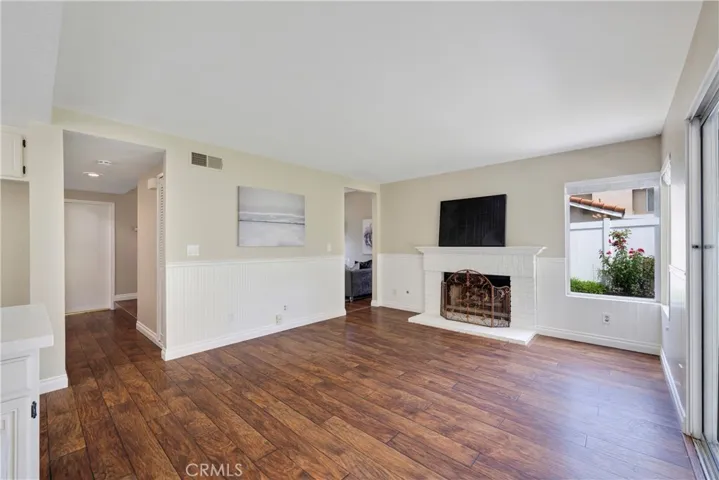 Family room boasts a gas fireplace & access to the living room.