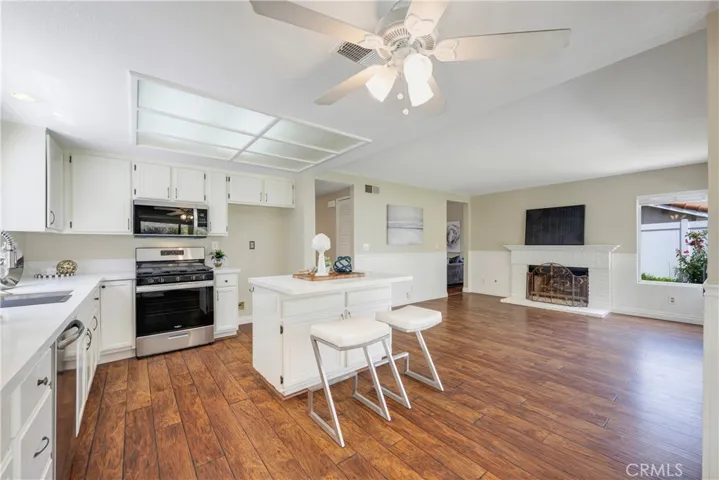 Open concept kitchen/family room has openings to living room & dining room.