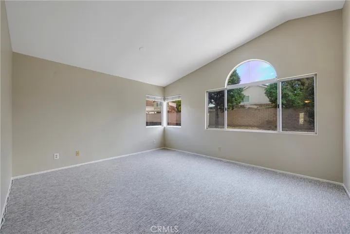 Primary bedroom has cathedral ceiling.