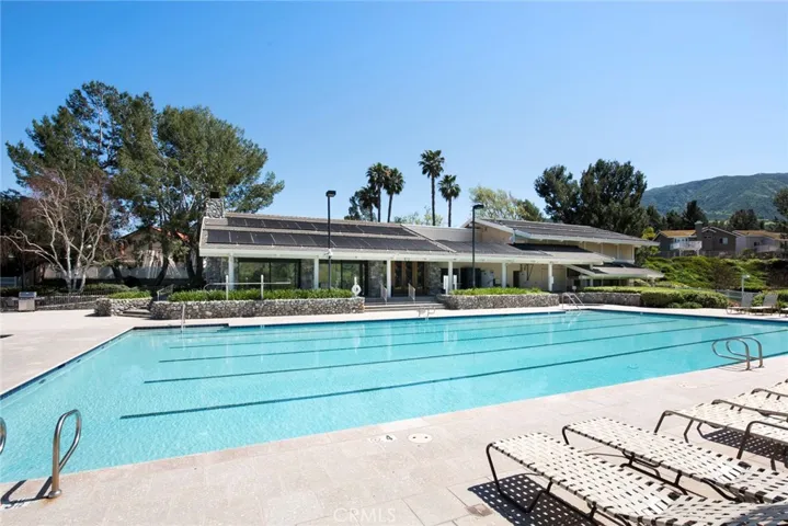 View of Association Clubhouse from lounges across pool.