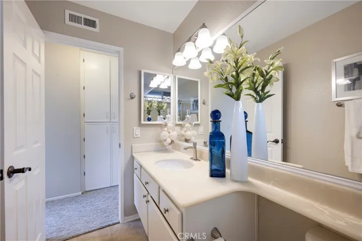 Second story hall bathroom has large mirror.