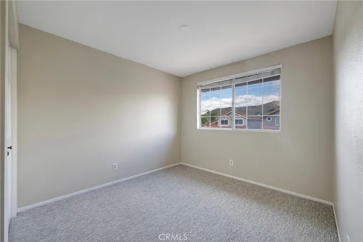 One of two secondary bedrooms facing the front of the house.