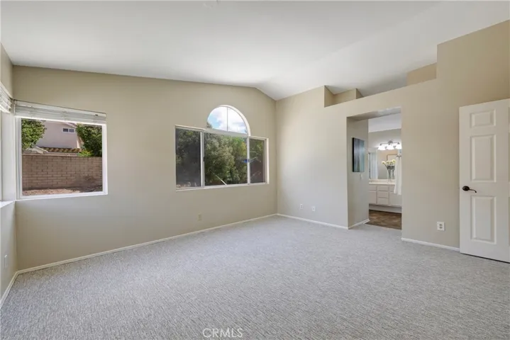 Primary bedroom has views to backyard.