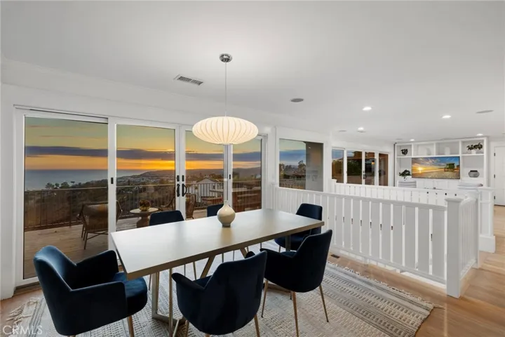 Dining room looking towards the family room, with a wall of glass showcasing the view.