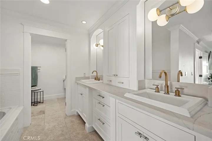 Updated, spa-like primary bath with a walk-in shower and separate soaking tub.