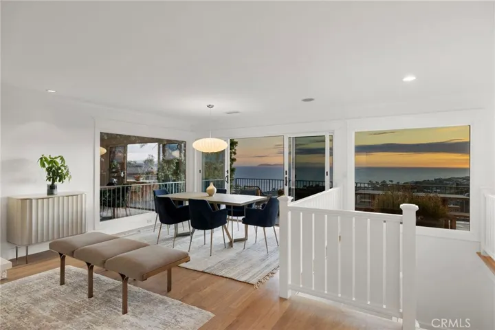 Living room open to the dining room with sliding doors leading to the expansive deck to enjoy the sunset.
