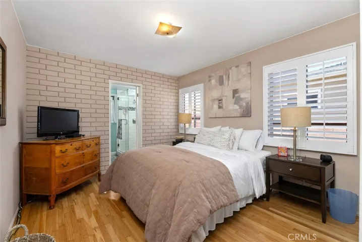 Master bedroom, plantation shutters and door into master bathroom