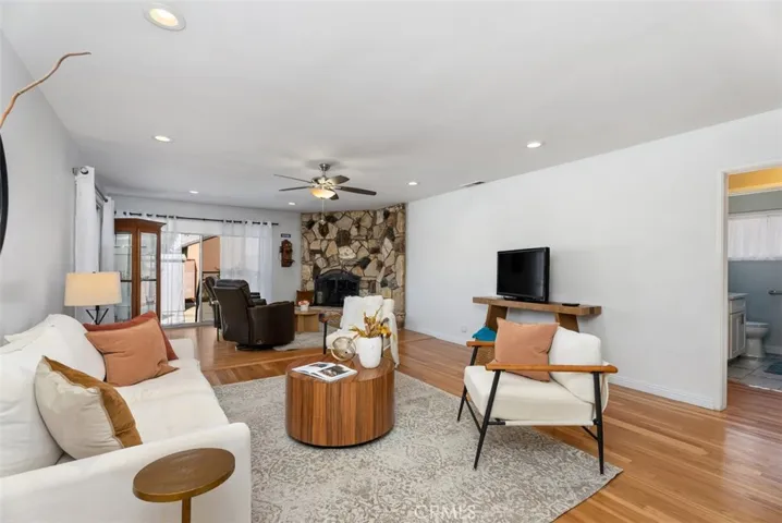 Very large living room with 2 focused areas for sitting, watching TV or chatting in front of the fireplace