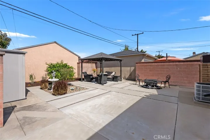 Rear yard with sitting area, landscaping, fire pit and lots of room for expanding entertainment area or extra parking
