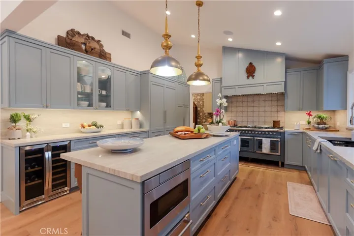 A one-of-a-kind, bespoke kitchen with 48" Thermador refrigerator, ILVE Nostagie II 60", 9 burner range, built-in beverage cooler and under-counter microwave.