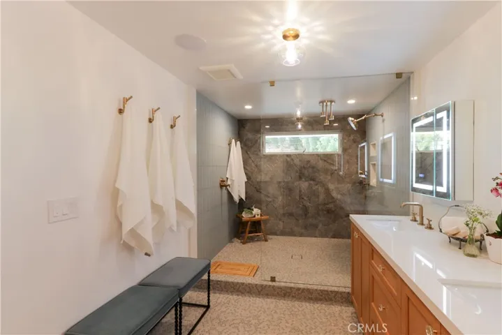 The primary suite shower is something to behold with multiple shower heads and high-end fixtures.