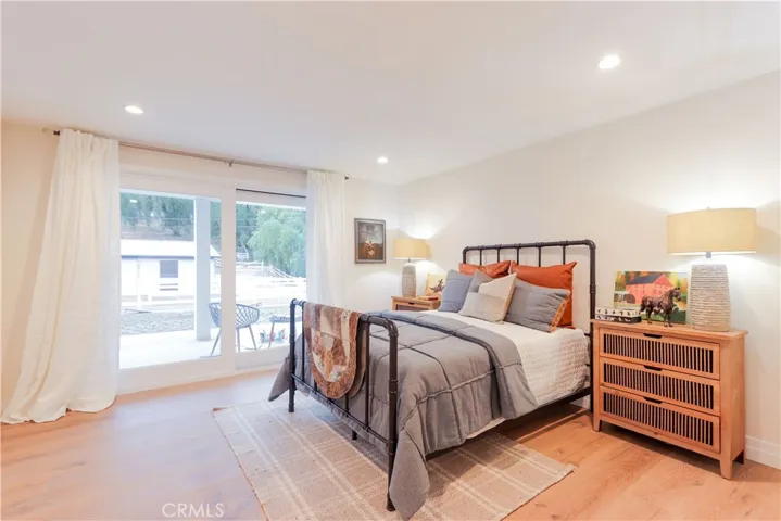 Staged as a boy's room, this secondary ensuite bedroom is well-appointed with direct patio access, abundant natural light and a relaxed indoor-outdoor feel.