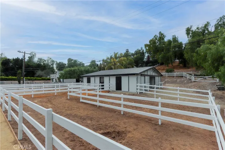 Spacious turnouts for all four horses. Plus, ample space behind the barn for trailer parking, and a utility sink and horse wash area. Directly out the back gate leads you to the Westfield riding ring for convenient exercise and training.
