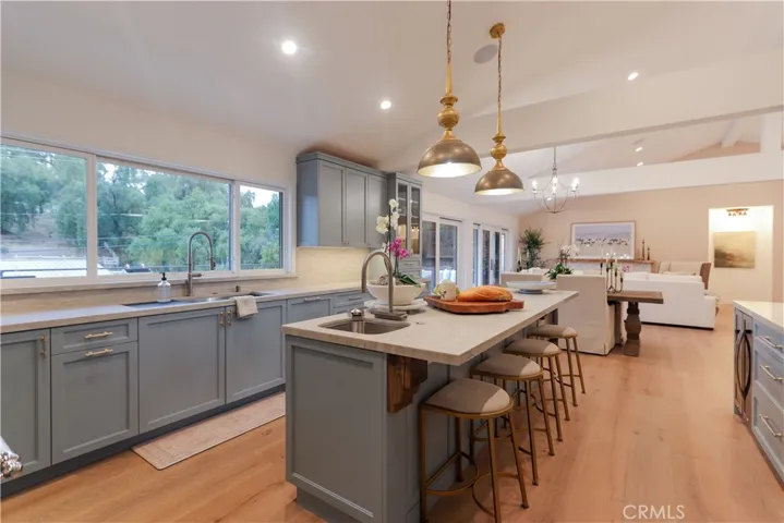 This open, family-style kitchen has it all! The prep sink with a waterfall vegetable wash, pull-down sprayer and built-in glass rinse for beverage and wine glasses makes entertaining and daily life a breeze!