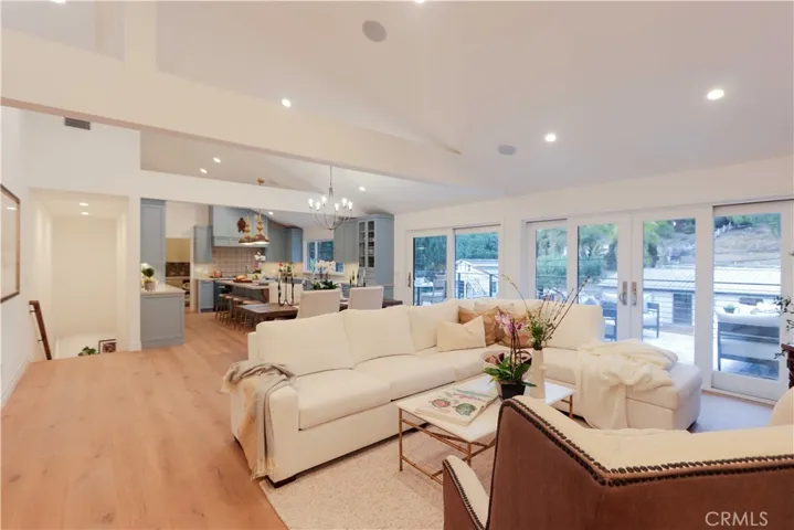 The open living room and it looks into the dining area and kitchen. Convenient access to the 630 square foot tumbled marble deck expands the living space.