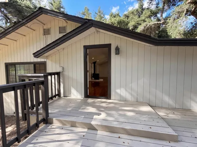 Exterior featuring vertical siding and a dark trim
