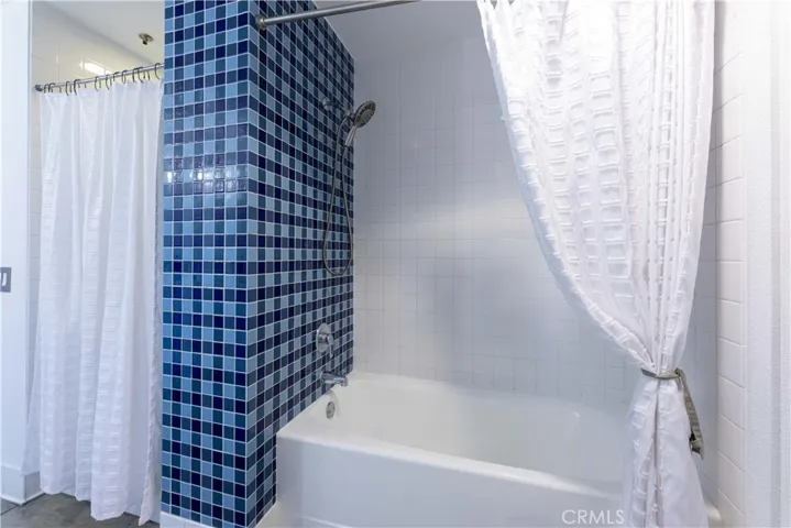 Shower on left and newly reglazed tub on right