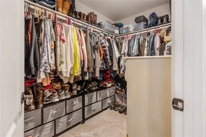 Primary bedroom walk in closet.