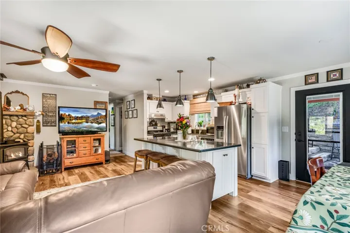 Living room open to kitchen with eat at bar.