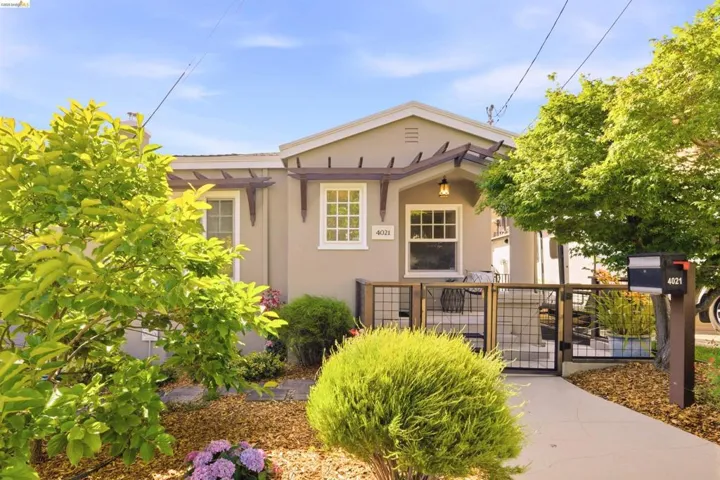 Stucco exterior with decorative wood corbels and a pergola-style overhang