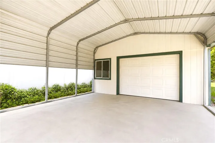 2 car detached 2 story garage with office space above with 2 car metal carport
