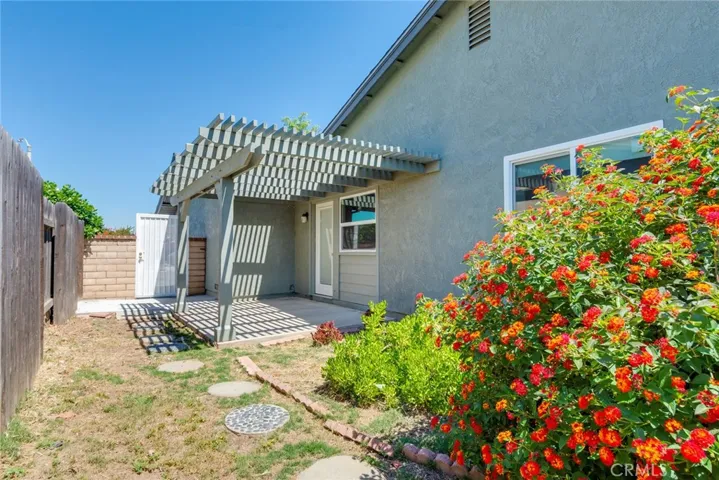 Side yard and patio with 2 year old trellis off primary bedroom.