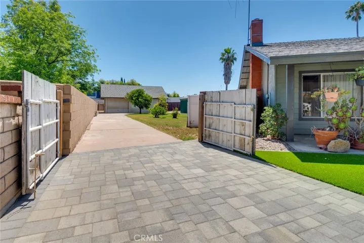 Gated access to rear yard parking and garage in detached workshop.
