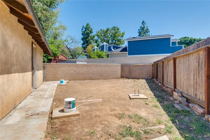 Rear yard behind workshop with footings for a cover.