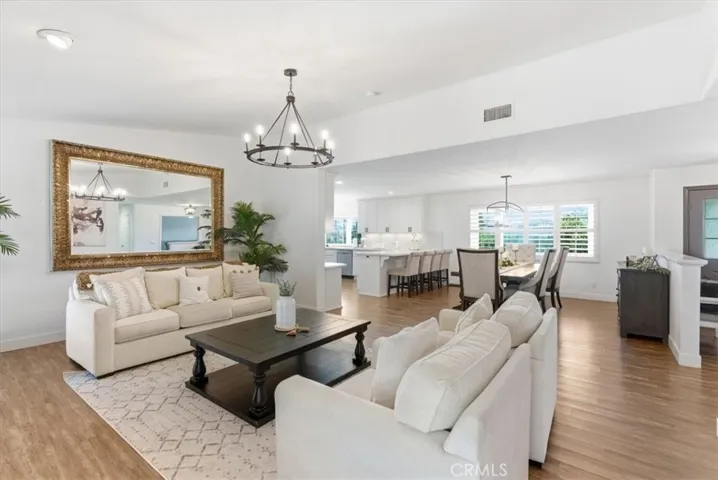 “Stunning open-concept living area featuring elegant finishes, abundant natural light, and seamless flow between the living room, dining space, and modern kitchen.”