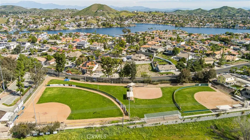 Drone view over 3 Little League Baseball fields w/ Lake in background