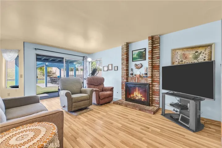 Brick fireplace makes a nice addition to this large Family Room