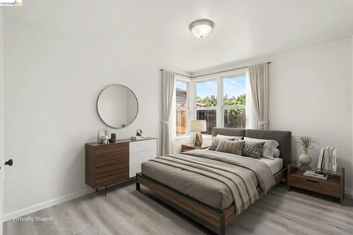 Bright room featuring light wood-finish flooring and white walls
