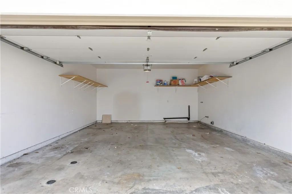 Generous 2 car garage, automatic garage door opener, washer/dryer hook up (gas/110V electric) and storage shelves