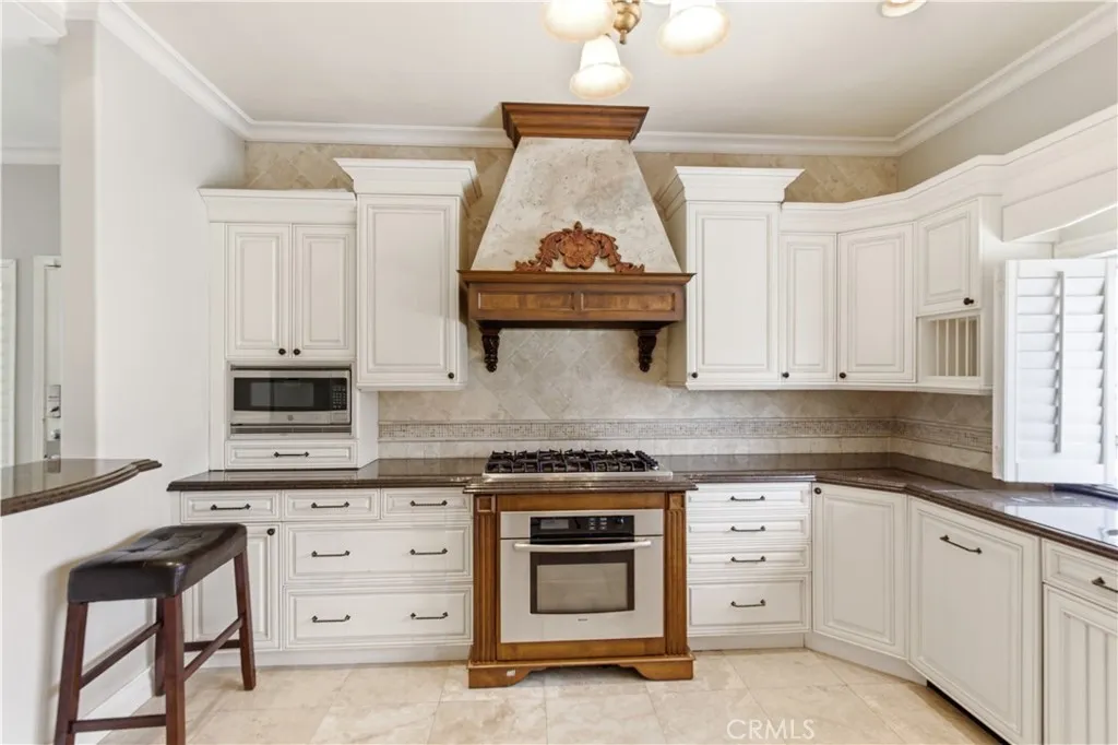 Mediteranean villa-by-the sea kitchen with ample cabinets and pan drawers with wrought iron handles