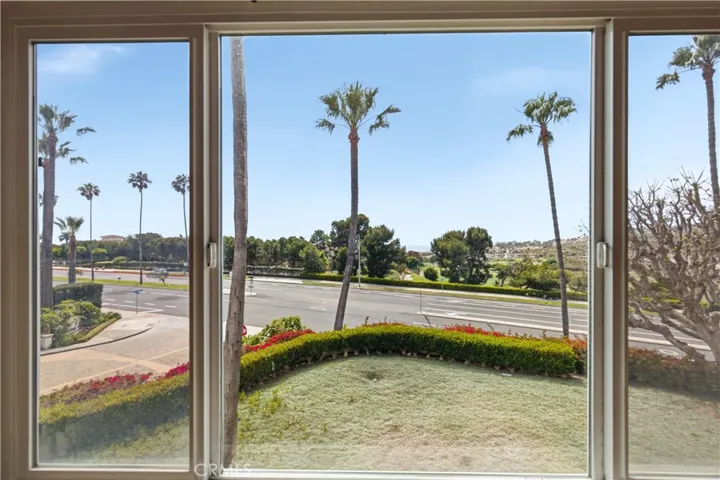 View from Primary bedroom window - view to ocean, Catalina Island and golf course surrounded by palm trees and green space