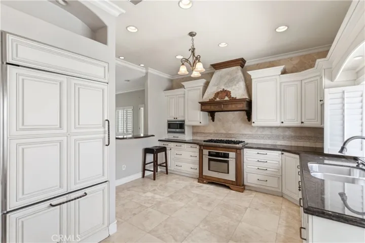 Kitchen with cabinet-faced refrigerator with freezer drawer and ice maker (included in lease)