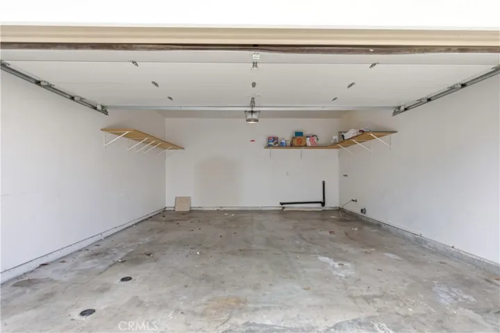 Generous 2 car garage, automatic garage door opener, washer/dryer hook up (gas/110V electric) and storage shelves