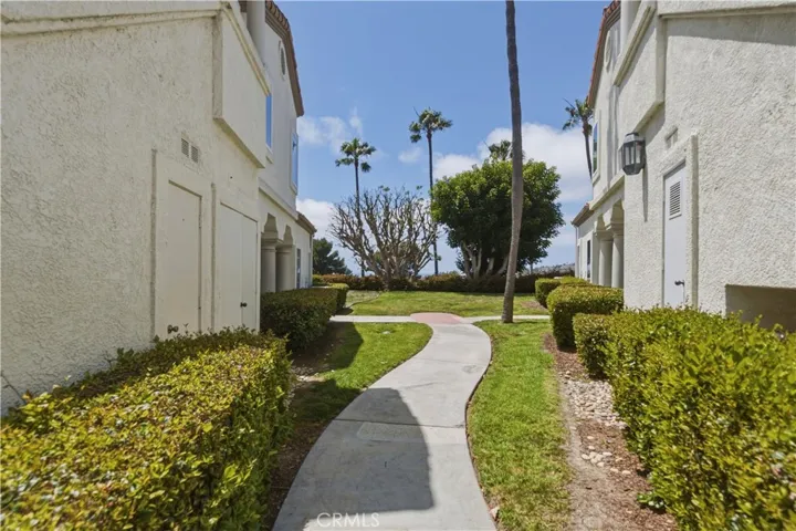 Sidewalk along side condo to utility closet and green space