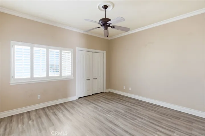 Bedroom 2 with closet, plantation shutters, and ceiling fan