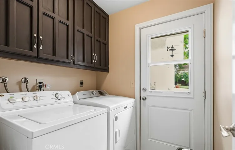 Interior laundry room has gas and electric dryer connections