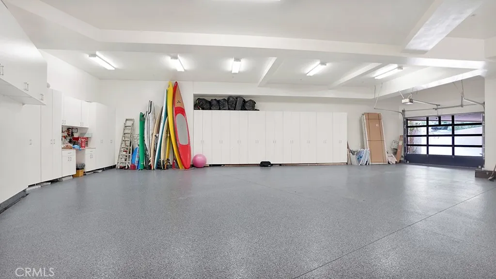 Garage easily holds 4-6 cars, subterranean. Lots of storage on three sides and high ceilings.