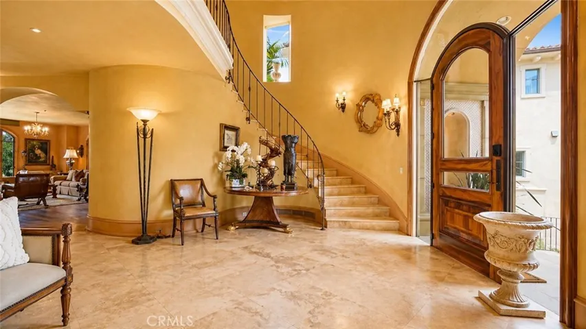 Two story Foyer with Large area open to second floor.  Custom Front door of Solid Walnut and Glass.